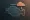 Abstract engine icon with a cloud and droplet, symbolizing poor fuel or toxic input affecting performance.