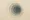 Abstract image of soft circular layers in muted tones, pulling inward to suggest the slow, subtle trap of alcohol dependence.